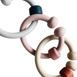 Anneau de dentition bébé silicone : Eden de couleur gris, rose et beige